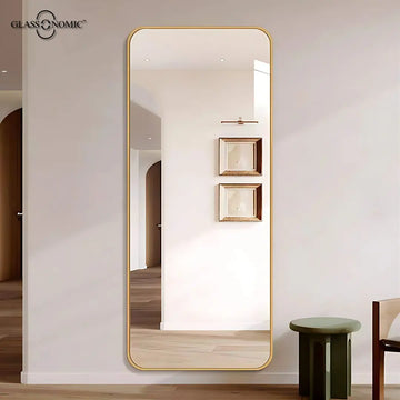 "Classic plain wall mirror with elegant gold frame in a hallway"