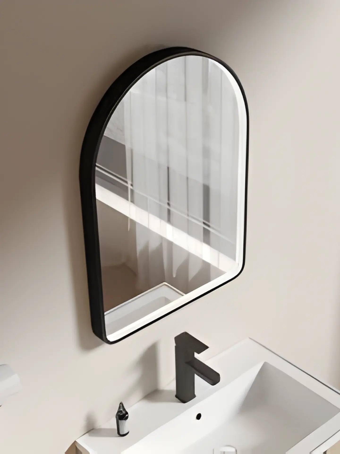 Bathroom vanity with a black-framed mirror and sink.