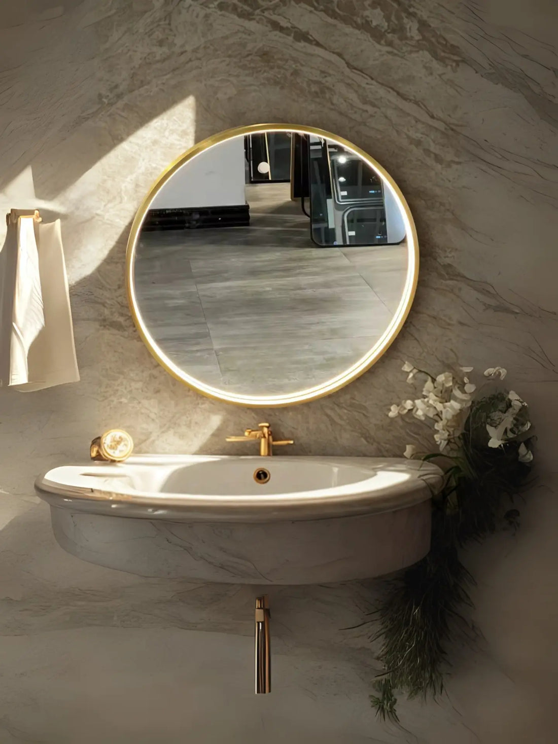 Two round mirrors on a marble wall above a bathroom vanity.
