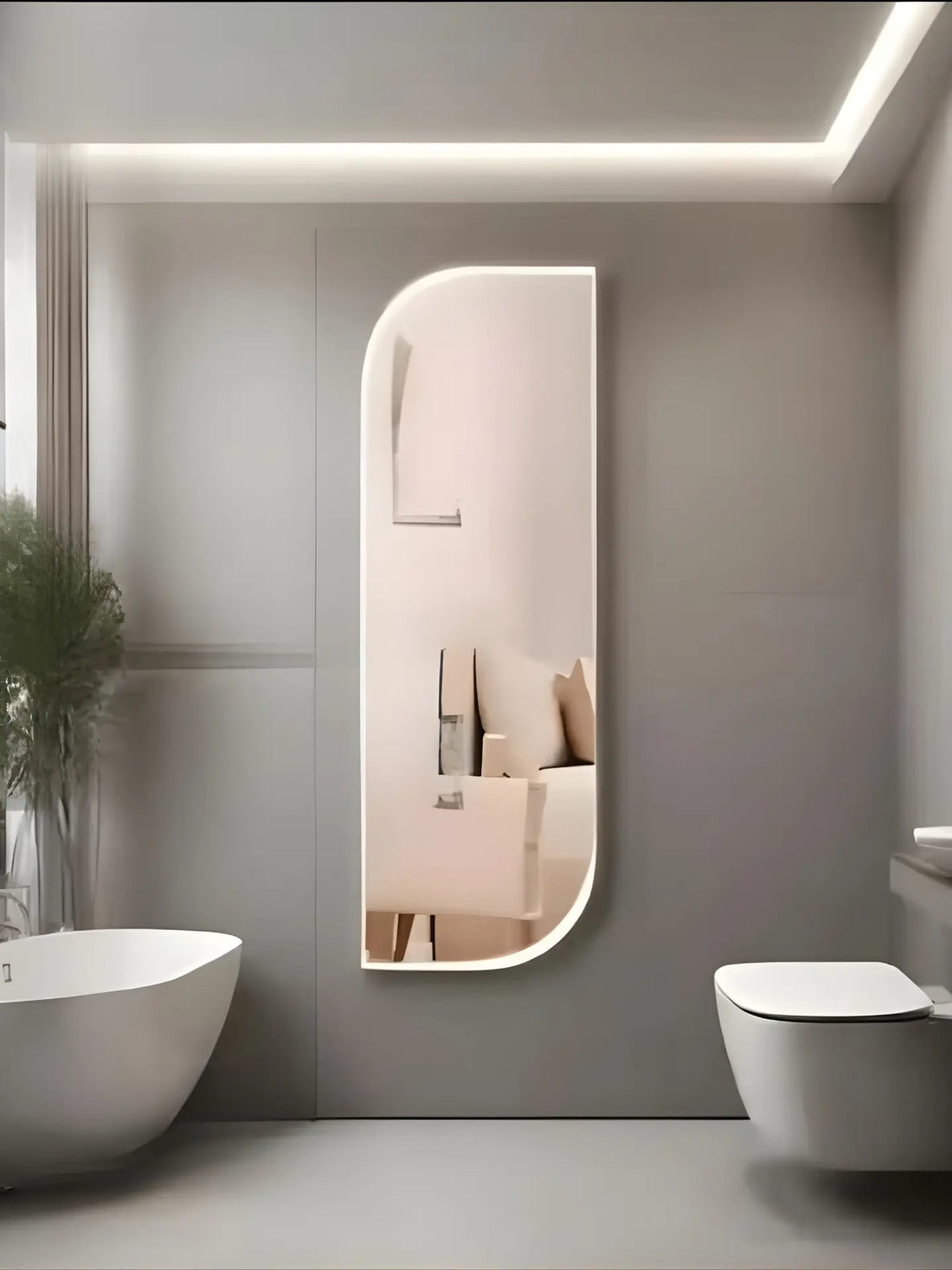 Modern bathroom with a large illuminated mirror, white bathtub, and toilet.