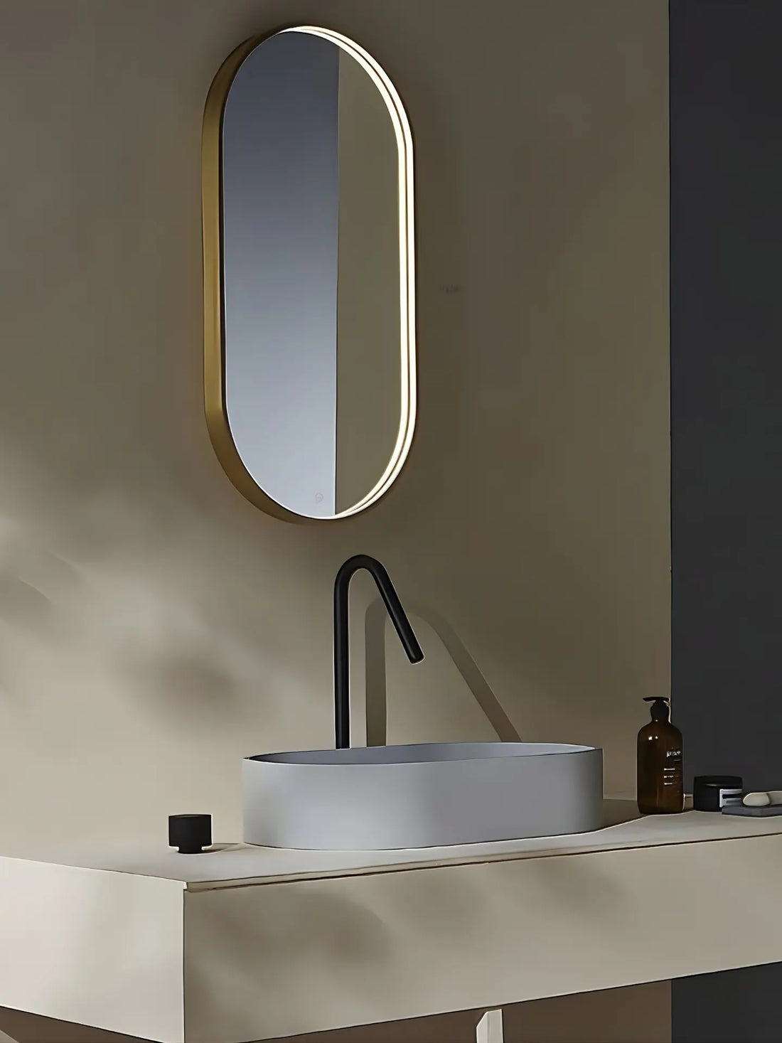 Bathroom vanity with oval mirror, sink, and minimal decor.