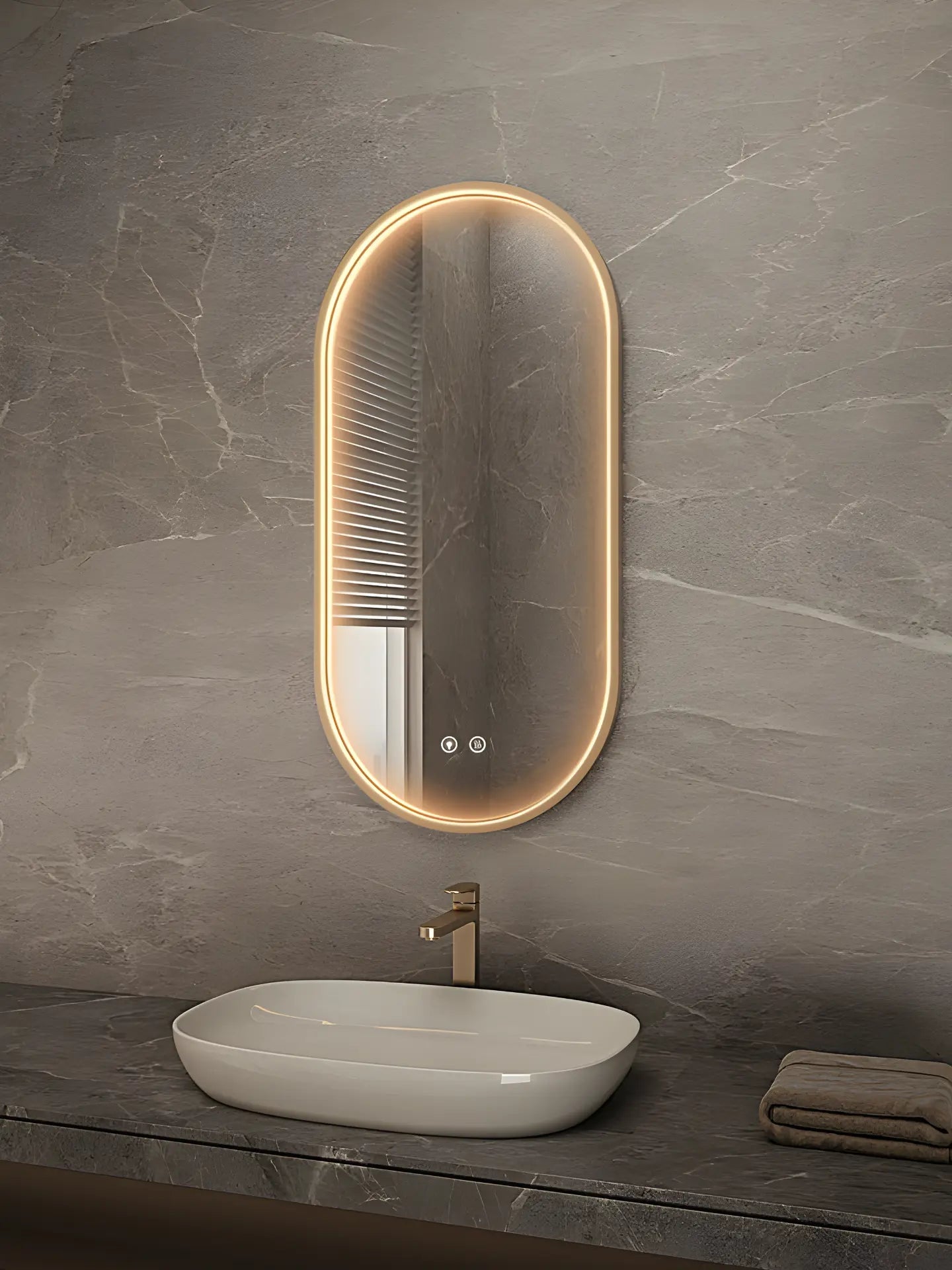 Bathroom vanity with a sink and illuminated oval mirror on a gray marble wall.