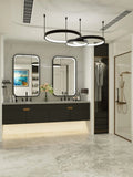 Modern bathroom with double vanity, mirrors, and a shower area.